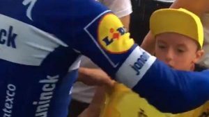 Julien Alaphilippe giving the yellow jersey to an icy cold child