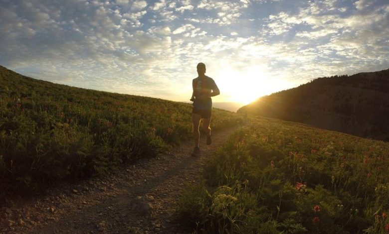 A sportsman running at dusk