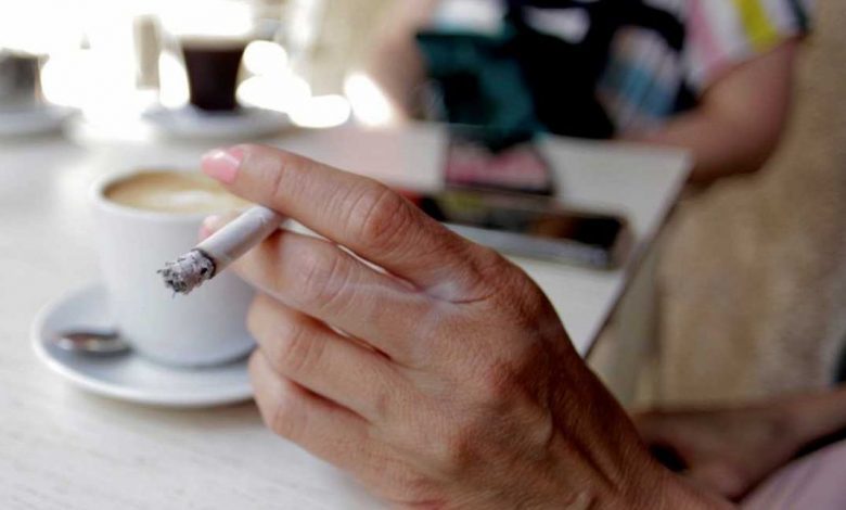 a person smoking in a cafeteria