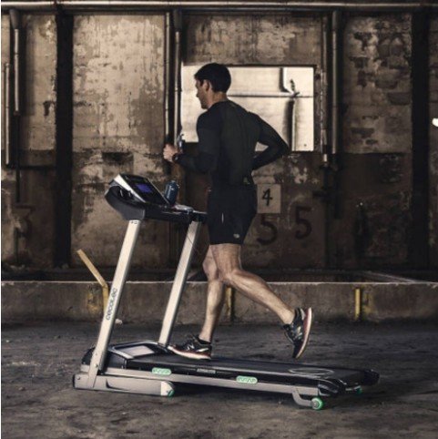 An athlete training on a treadmill at home