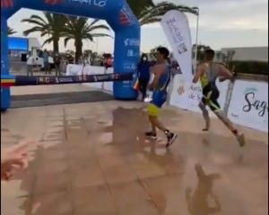 He stops before the finish line to celebrate the victory in a triathlon and is overtaken by another triathlete