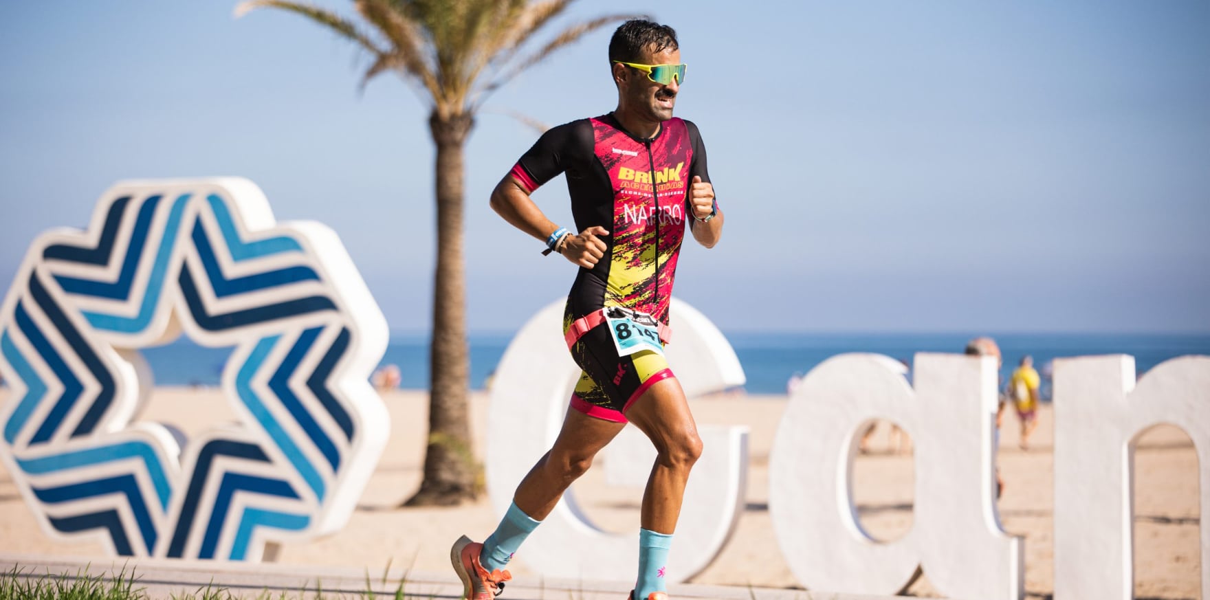 Imagen de un triatleta corriendo en la playa de Gandia