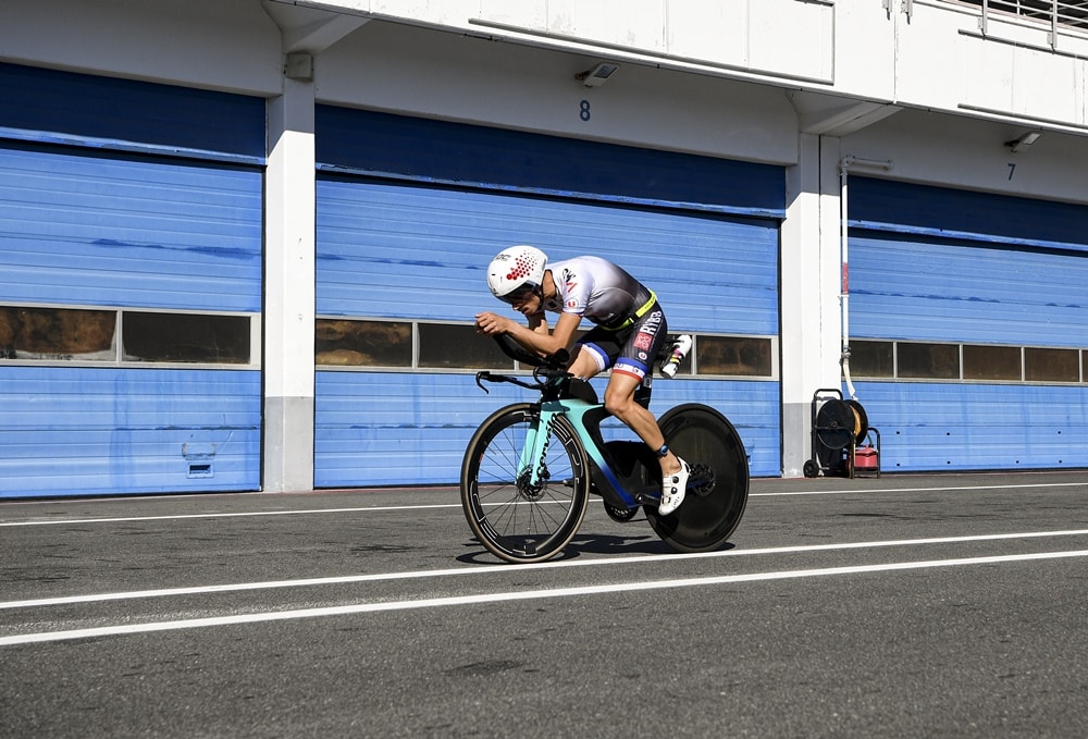 Octavio Passos/Getty Images for IRONMAN) / a triathlete on the F1 circuit