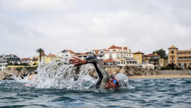 A swimmer with Cascais in the background