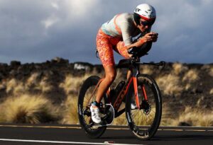 IRONMAN/ imagen de una triatleta en el ciclismo de Kona