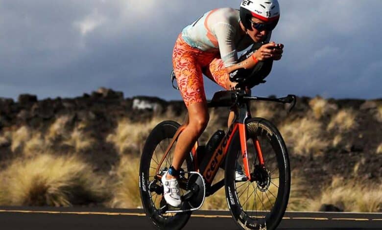 IRONMAN/ image of a triathlete in Kona cycling