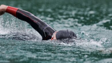 Canva/ a triathlete swimming in open water