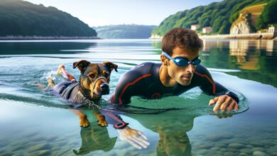 A triathlete and his pet coming out of the water