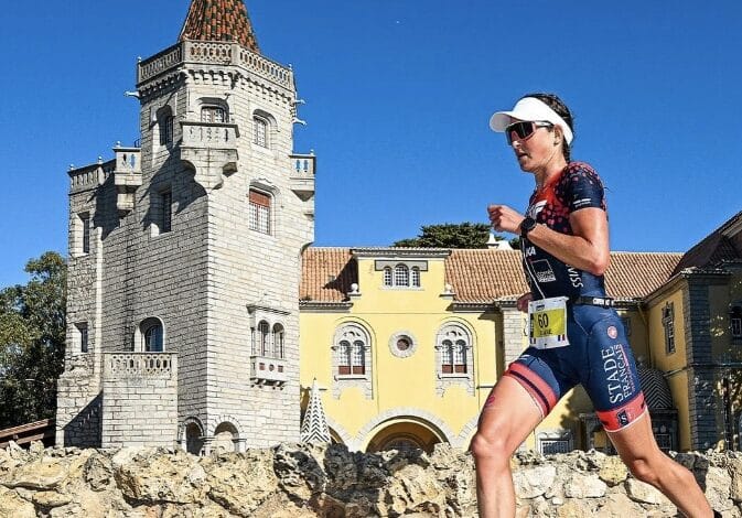 IRONMAN/ image of a triathlete running in Cascais