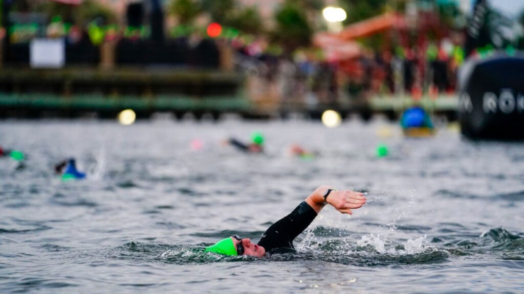 Participantes nadando durante el segmento de natación del IRONMAN Texas 2026 en Lake Woodlands