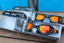 Two pairs of Zoggs Predator Flex Titanium goggles in their boxes on a table